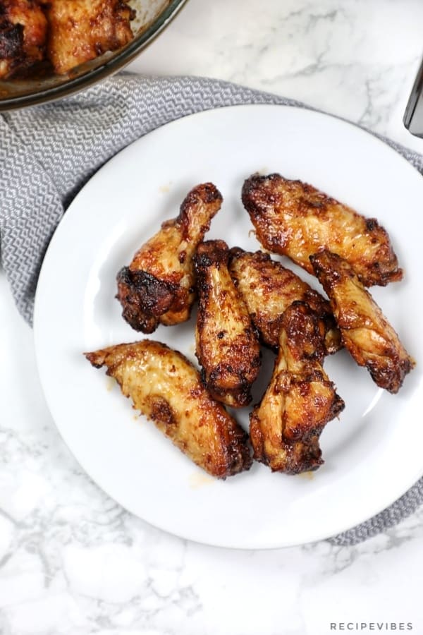 air fryer chicken wings served on a flat white plate.