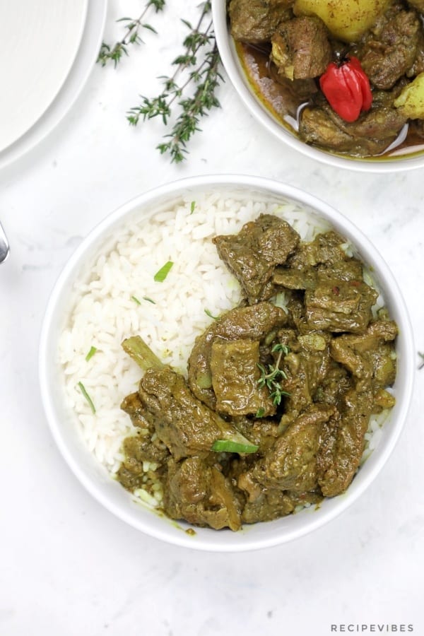 curry goat served on white rice.