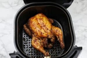 chicken breast side up in the air fryer basket.