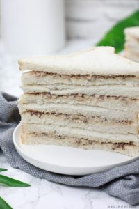 sardine sandwiches served on a white plate.