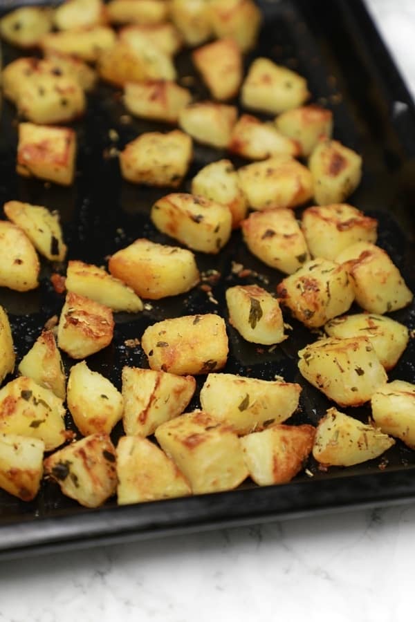 The roasted potatoes in baking tray