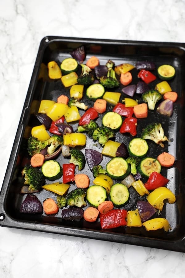 Roasted veggies in a baking tray.