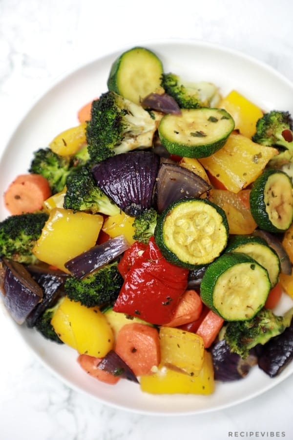 Roasted vegetables served on a white plate.