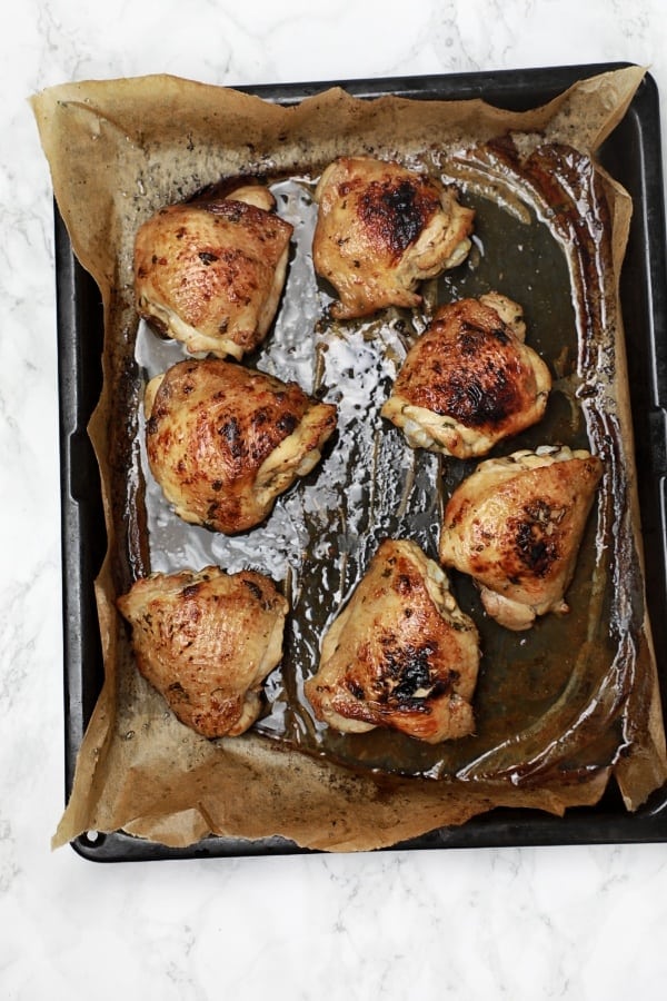 Lime baked chicken inside baking tray.