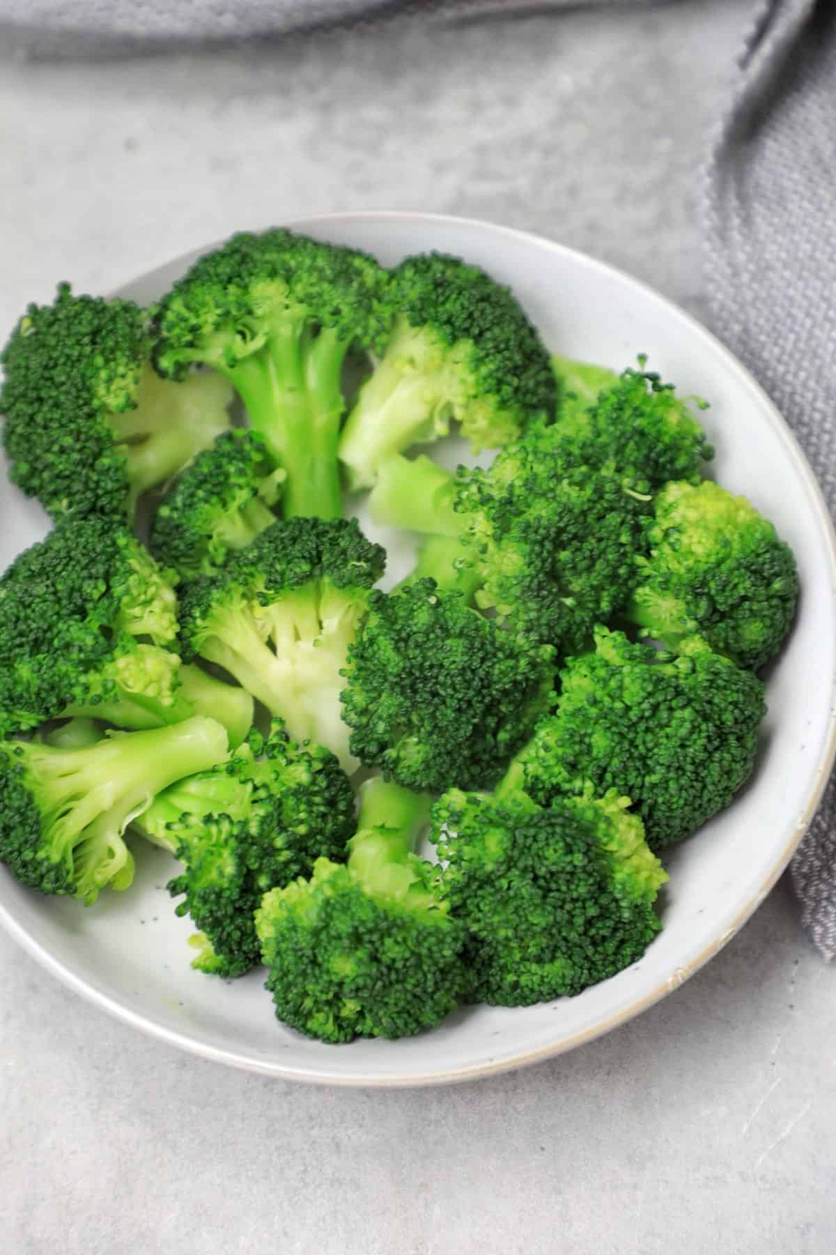 boiled broccoli served on a plate.