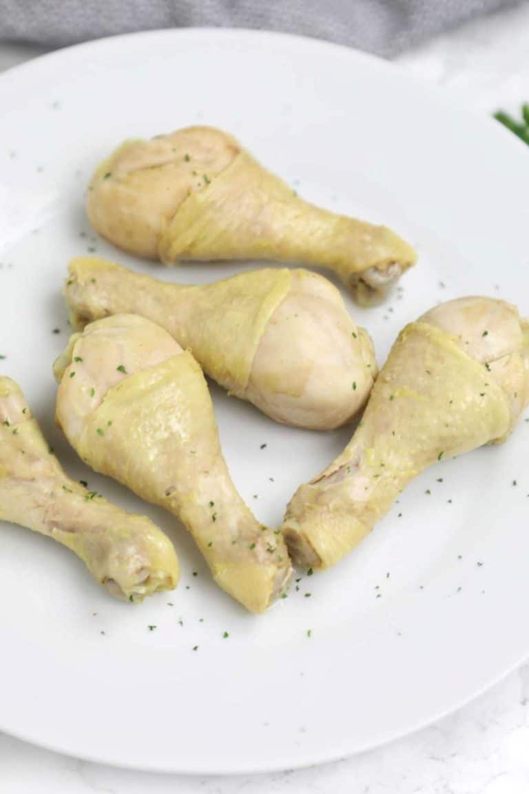 boiled chicken drumsticks on a white plate.
