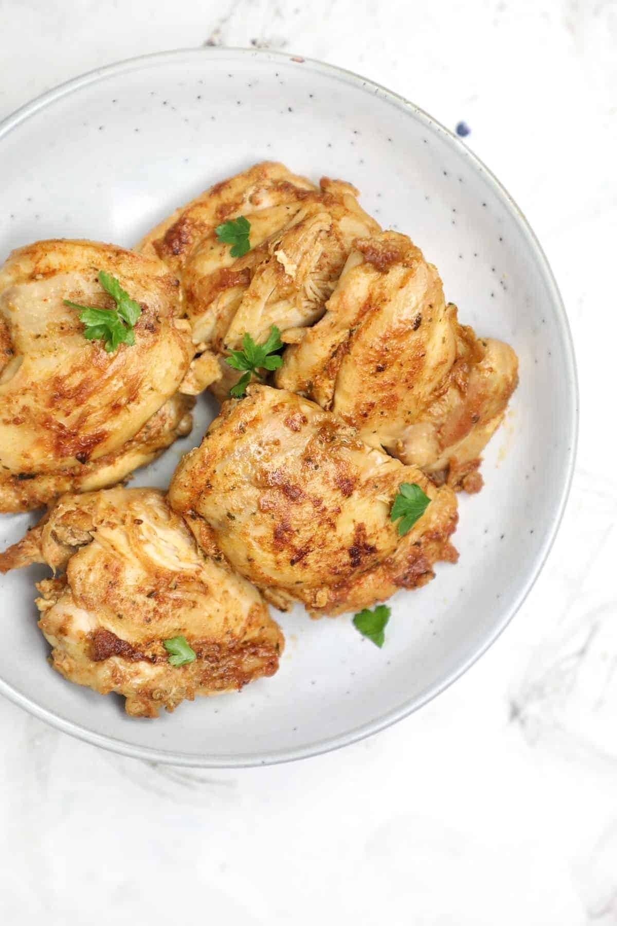 instant pot boneless chicken thighs served on a plate.
