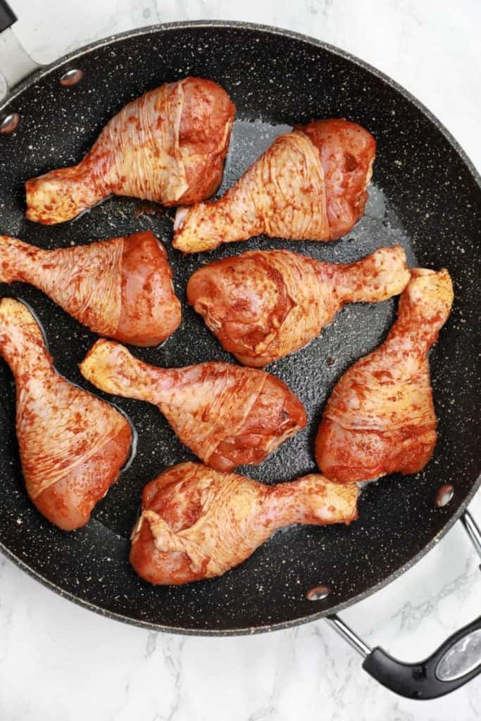 the chicken arranged in the skillet.