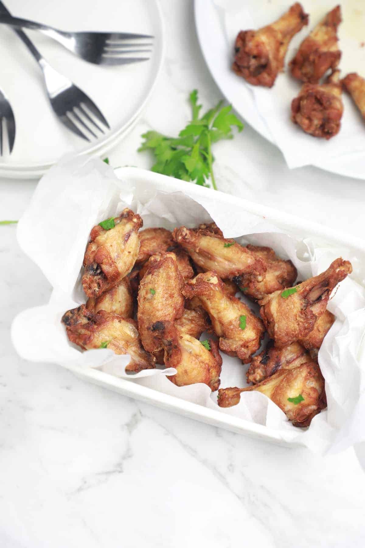 the cooked wings in a serving basket.