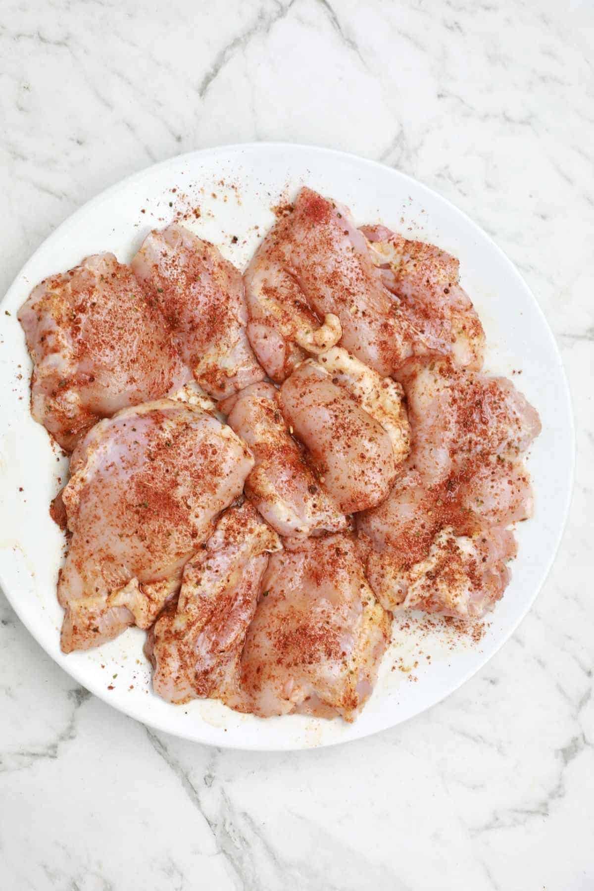 chicken thighs coated in seasoning.