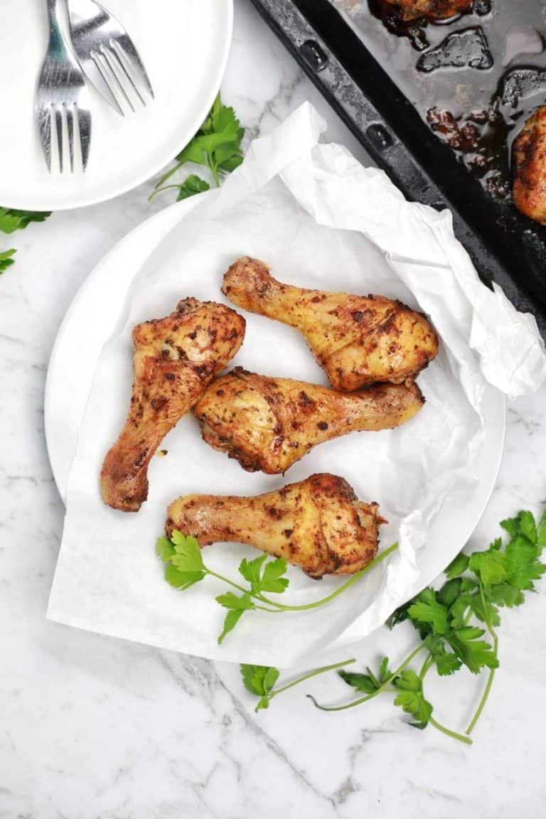cooked chicken drumsticks on a plate.