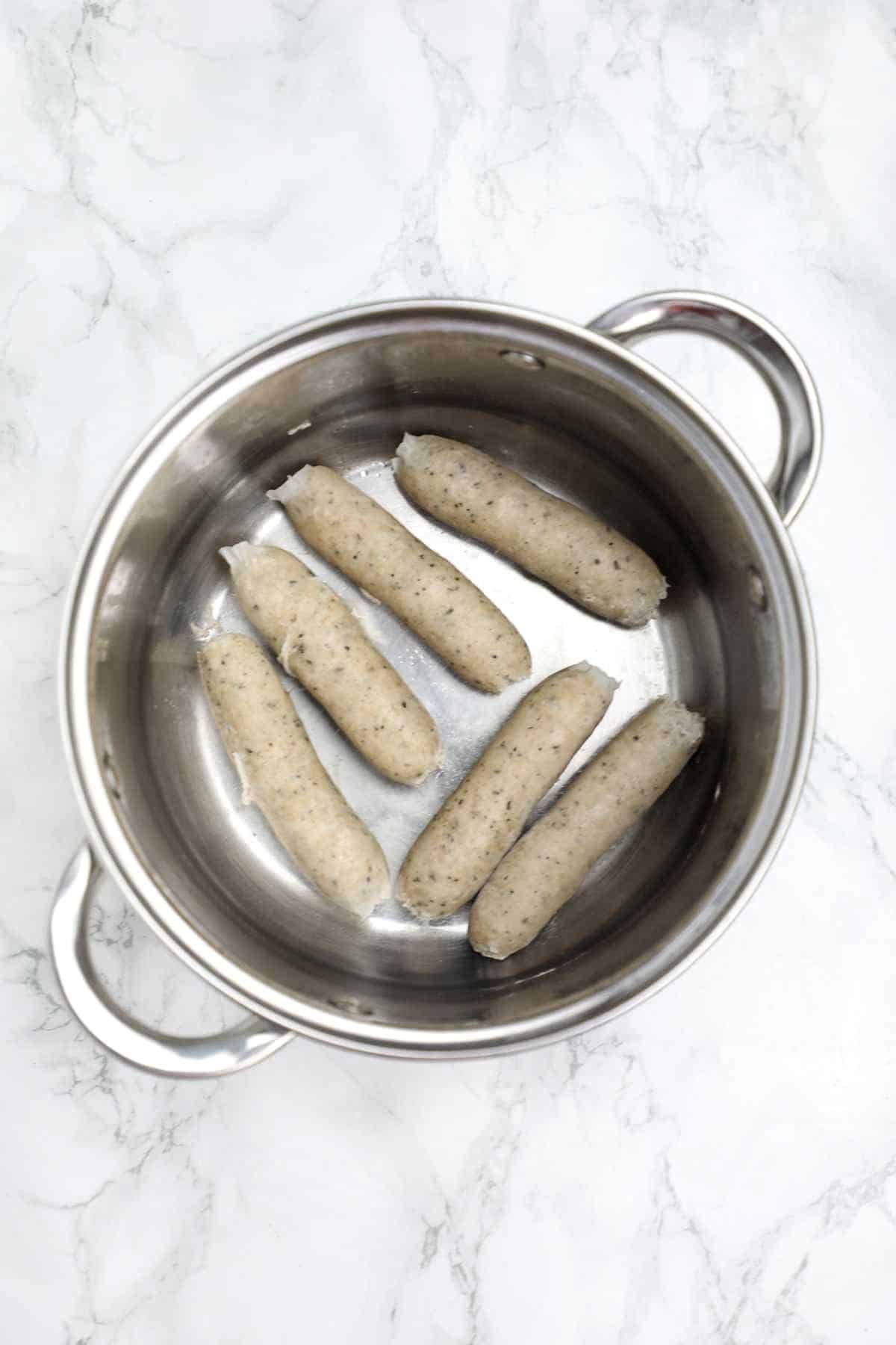 cooked sausages displayed in the pot.