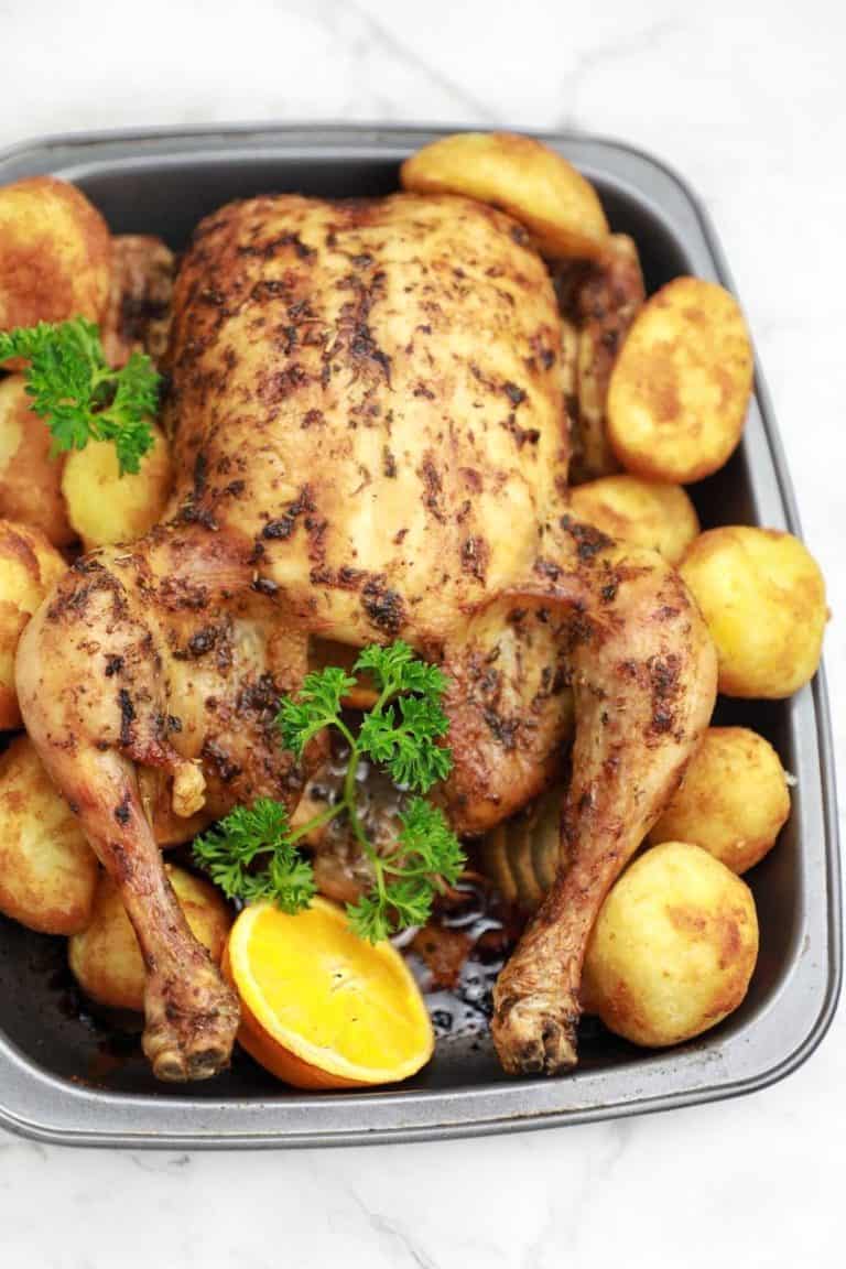 whole christmas chicken in a baking dish.