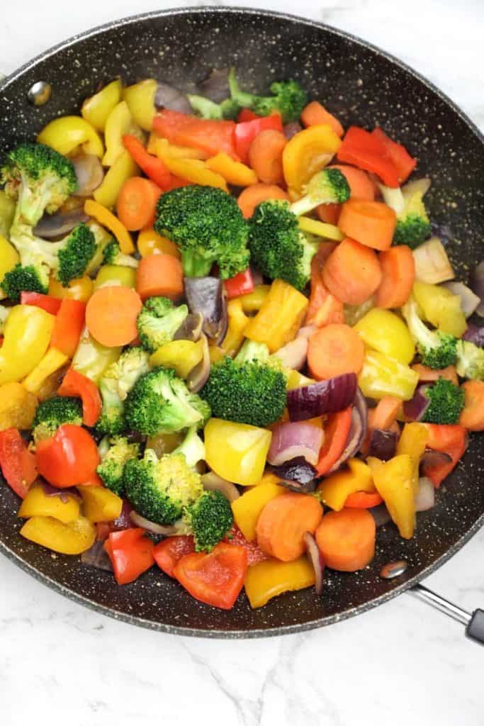 fried vegetables in a pan.