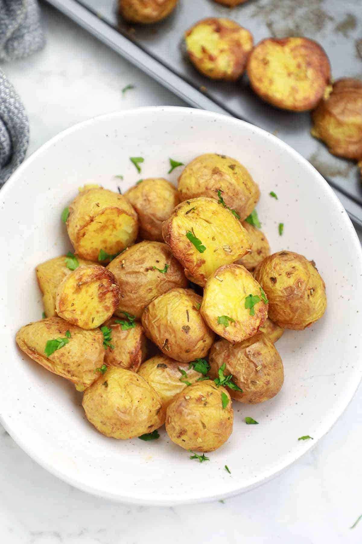 roasted baby potatoes served and garnished with parsley.