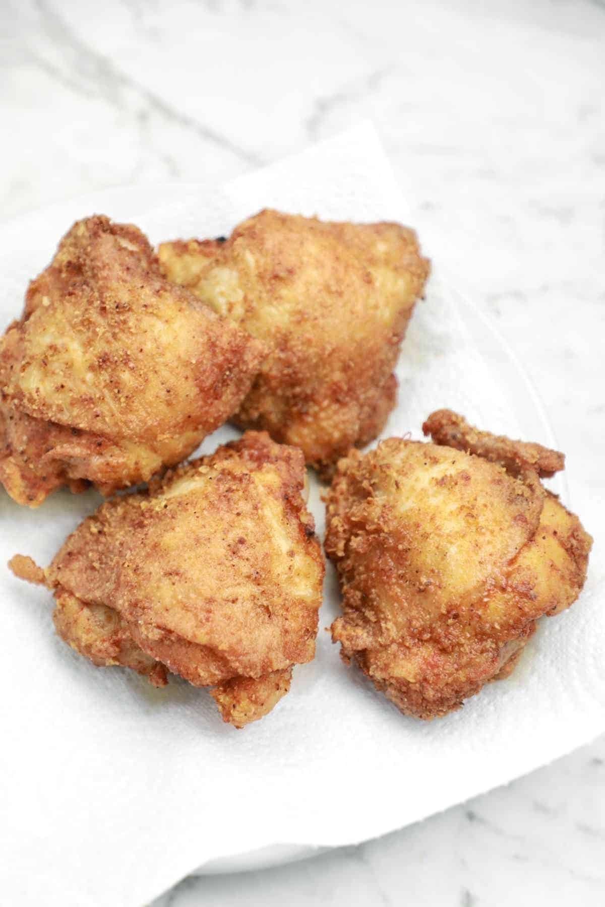 fried chicken thighs on a plate.