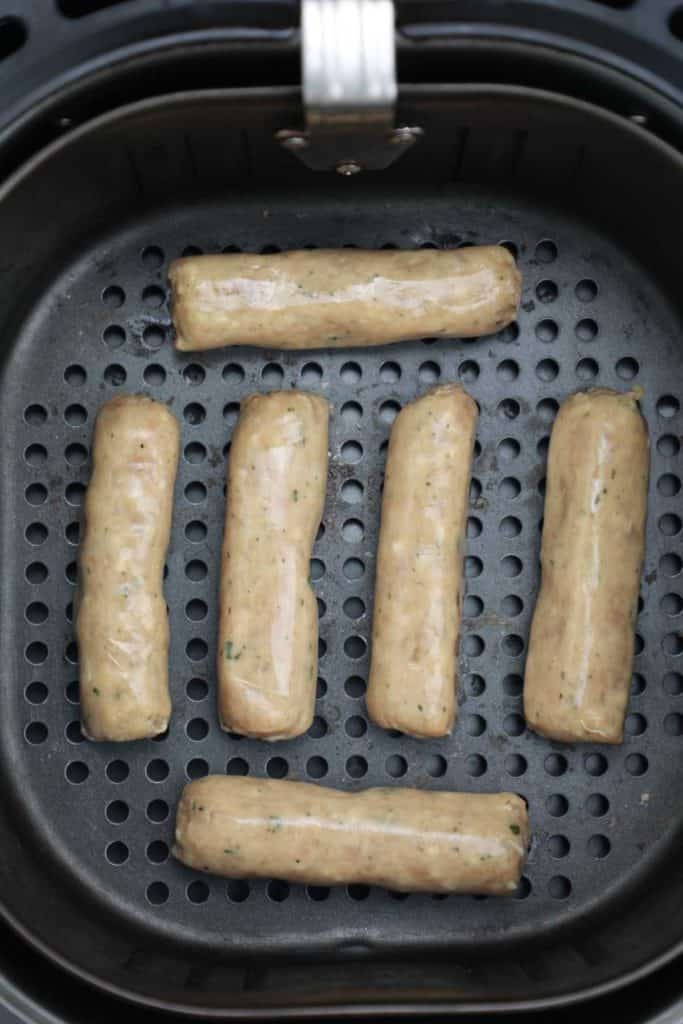sausages arranged in air fryer.