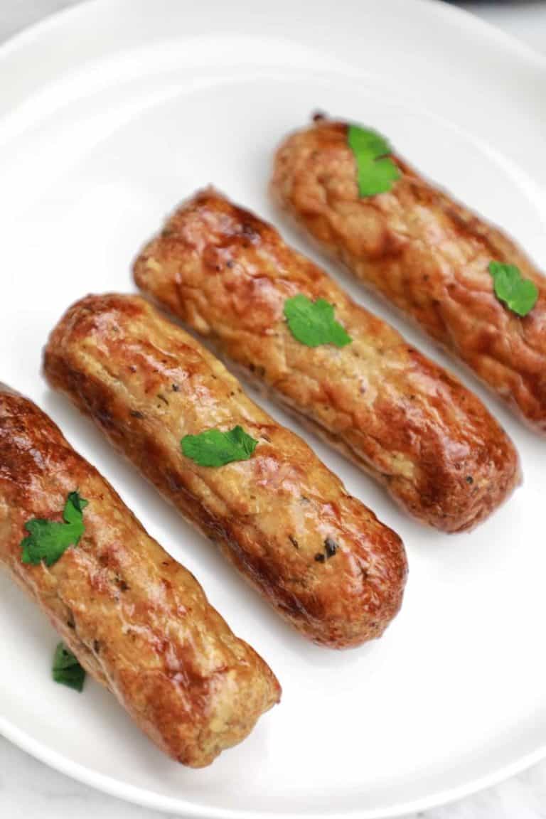 air fryer sausages on a white plate.