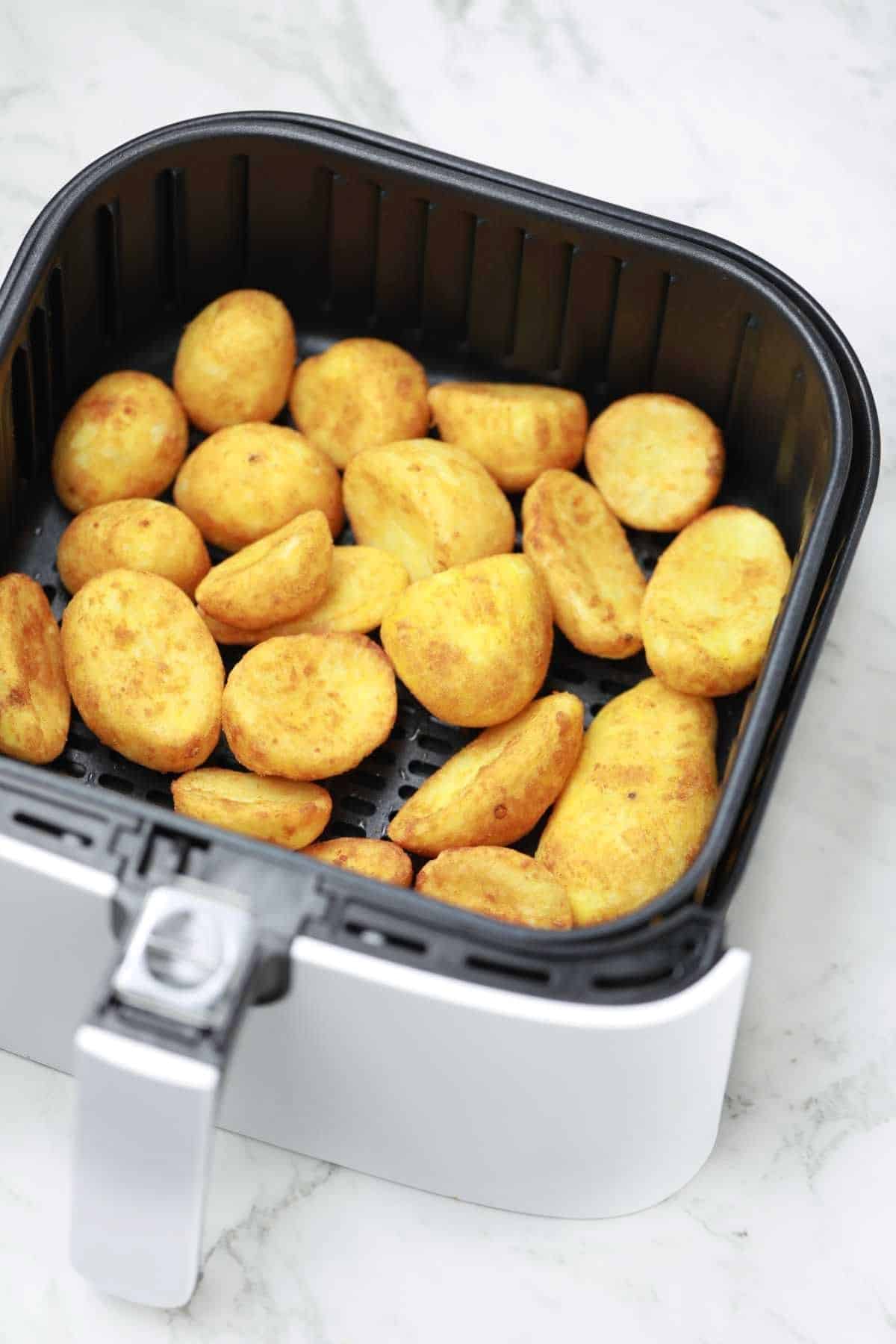 air fried frozen potatoes displayed in air fryer.