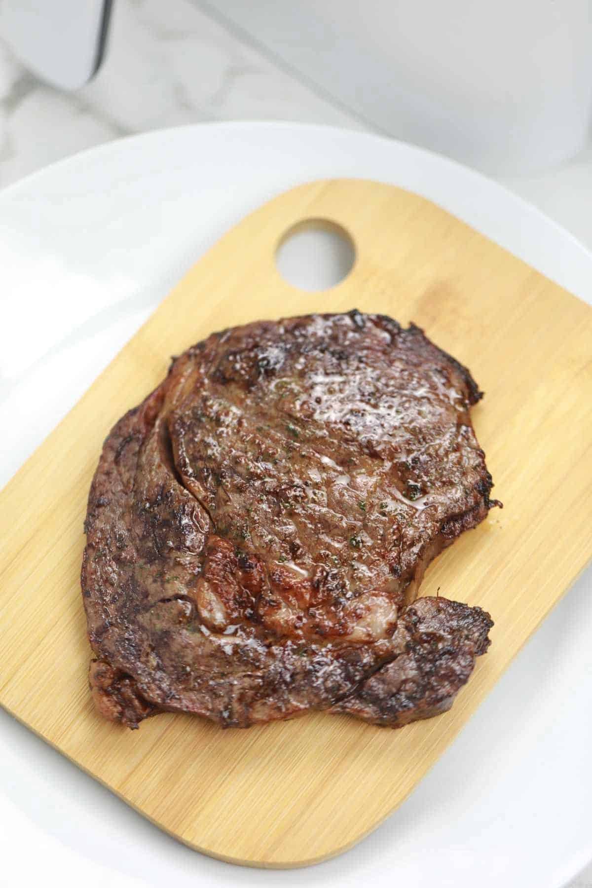 air fryer steak on a chopping board.