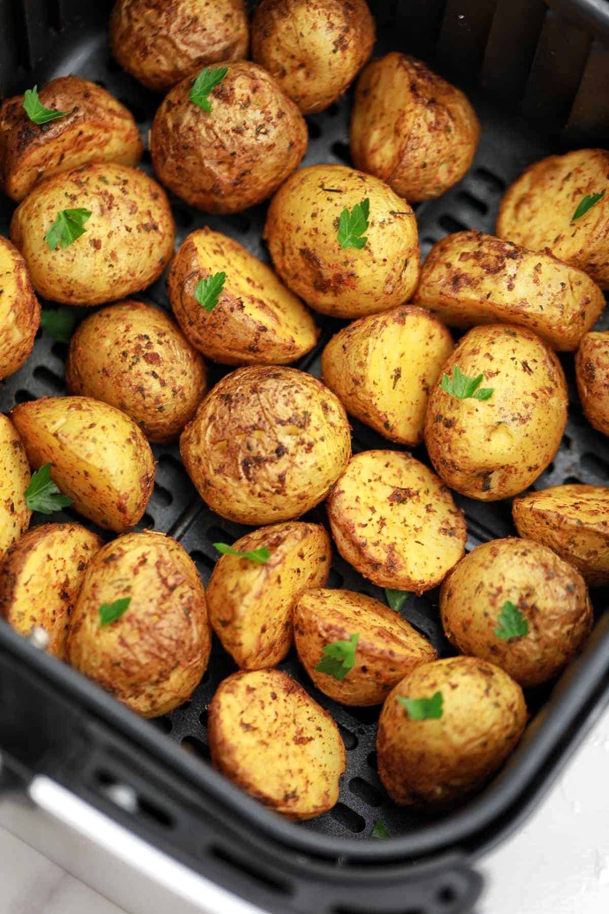 air fried baby potatoes displayed in air fryer.