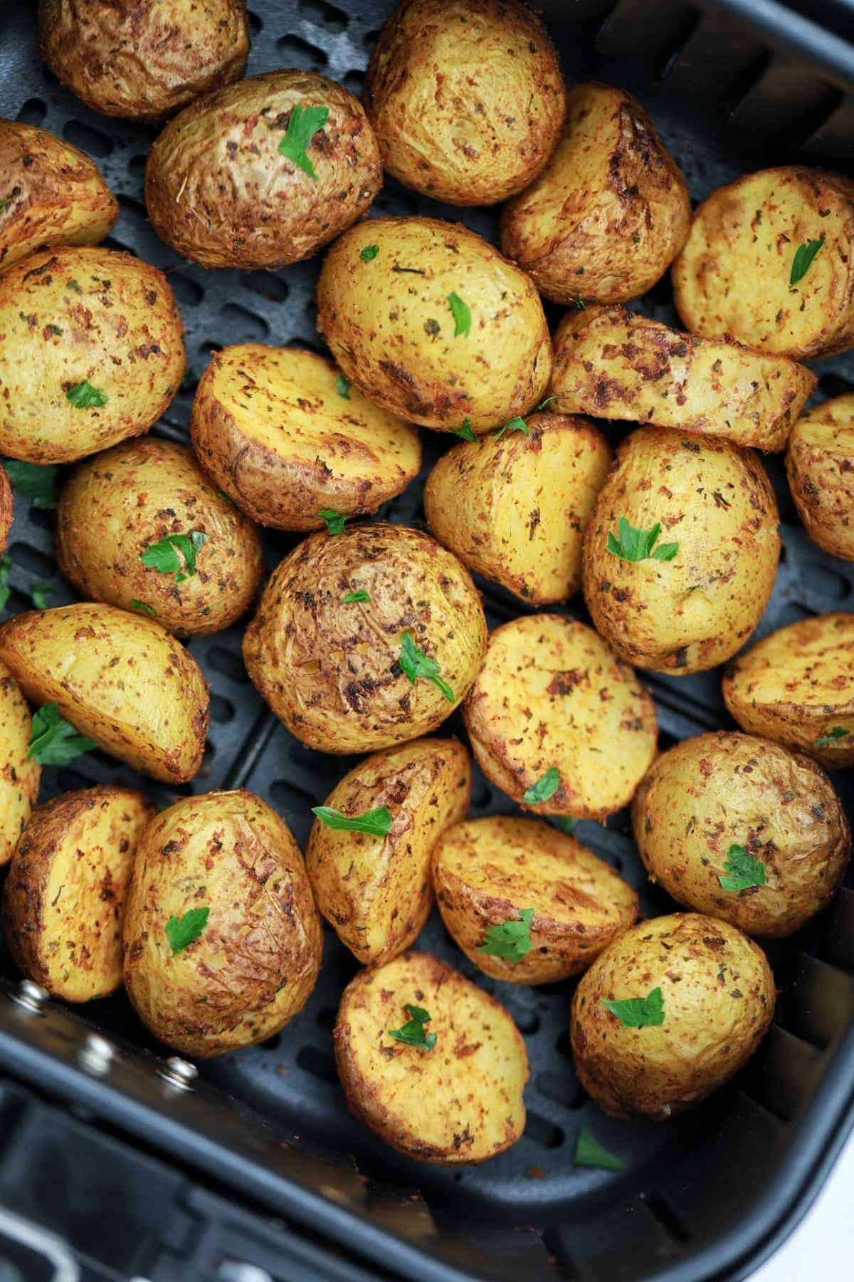 roasted baby potatoes in air fryer basket.