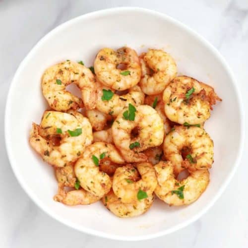 air fryer shrimp served and garnished with parsley.