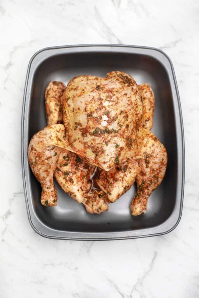 the chicken placed on a baking tray.