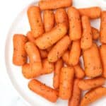 air fryer baby carrots served on a white plate.