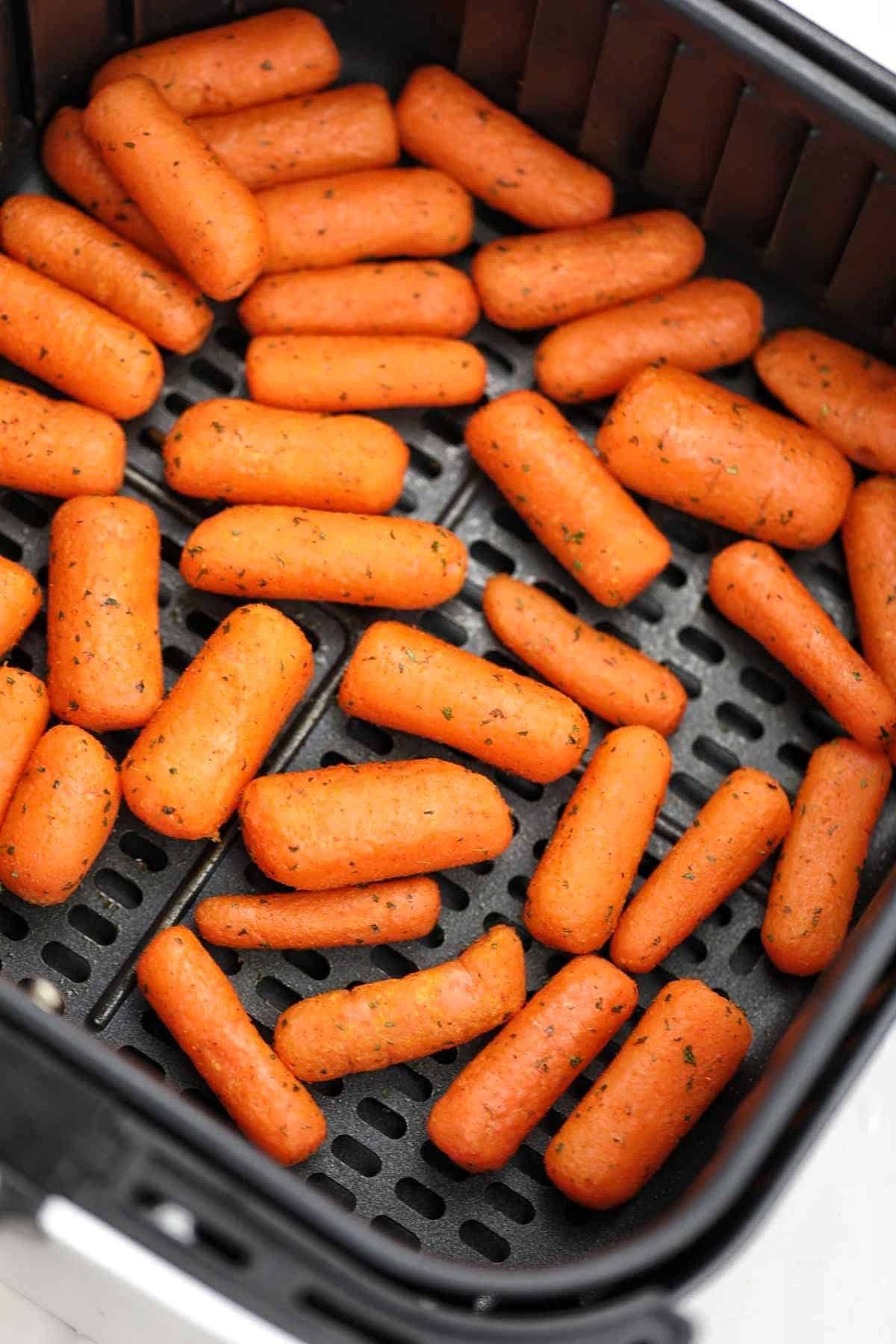 air fryer baby carrots in air fryer basket.