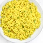 yellow rice served on a plate.