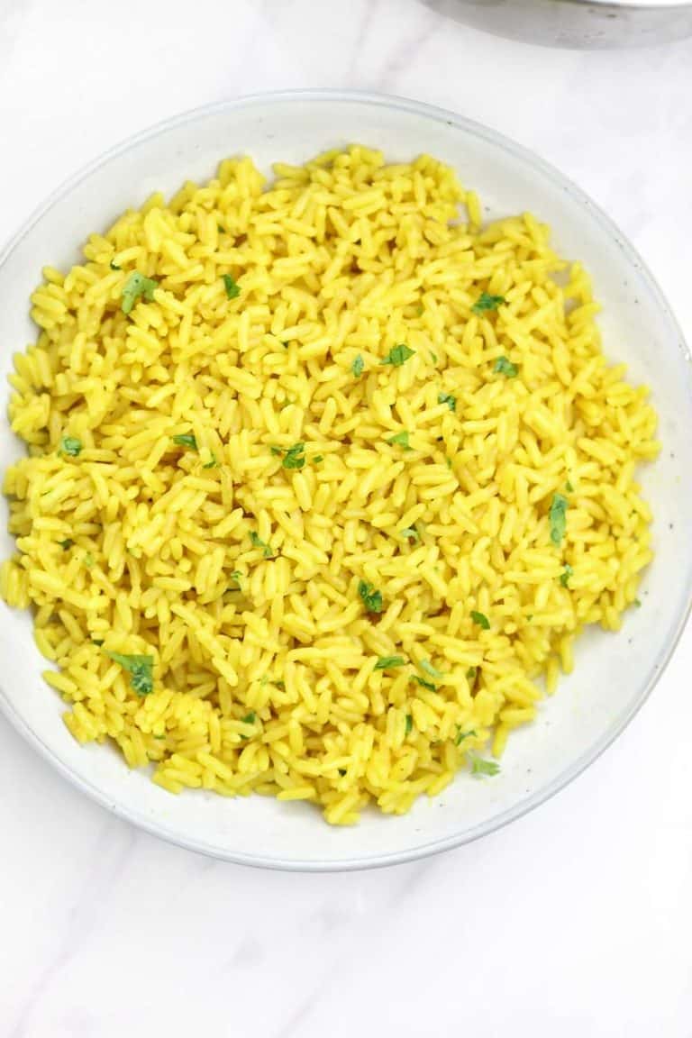 yellow rice served on a plate.