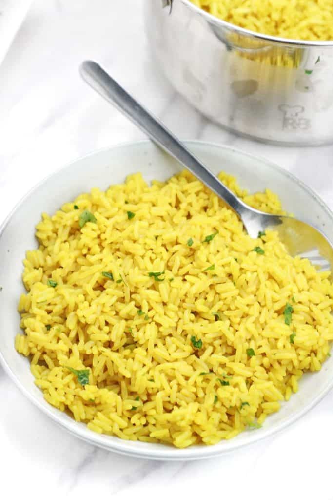 yellow rice served with parsley garnish.