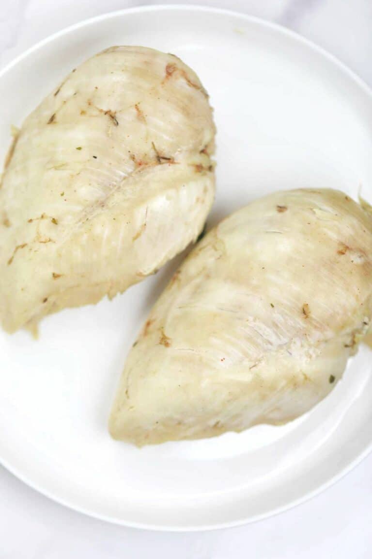 Boiled chicken breasts served on a plate.