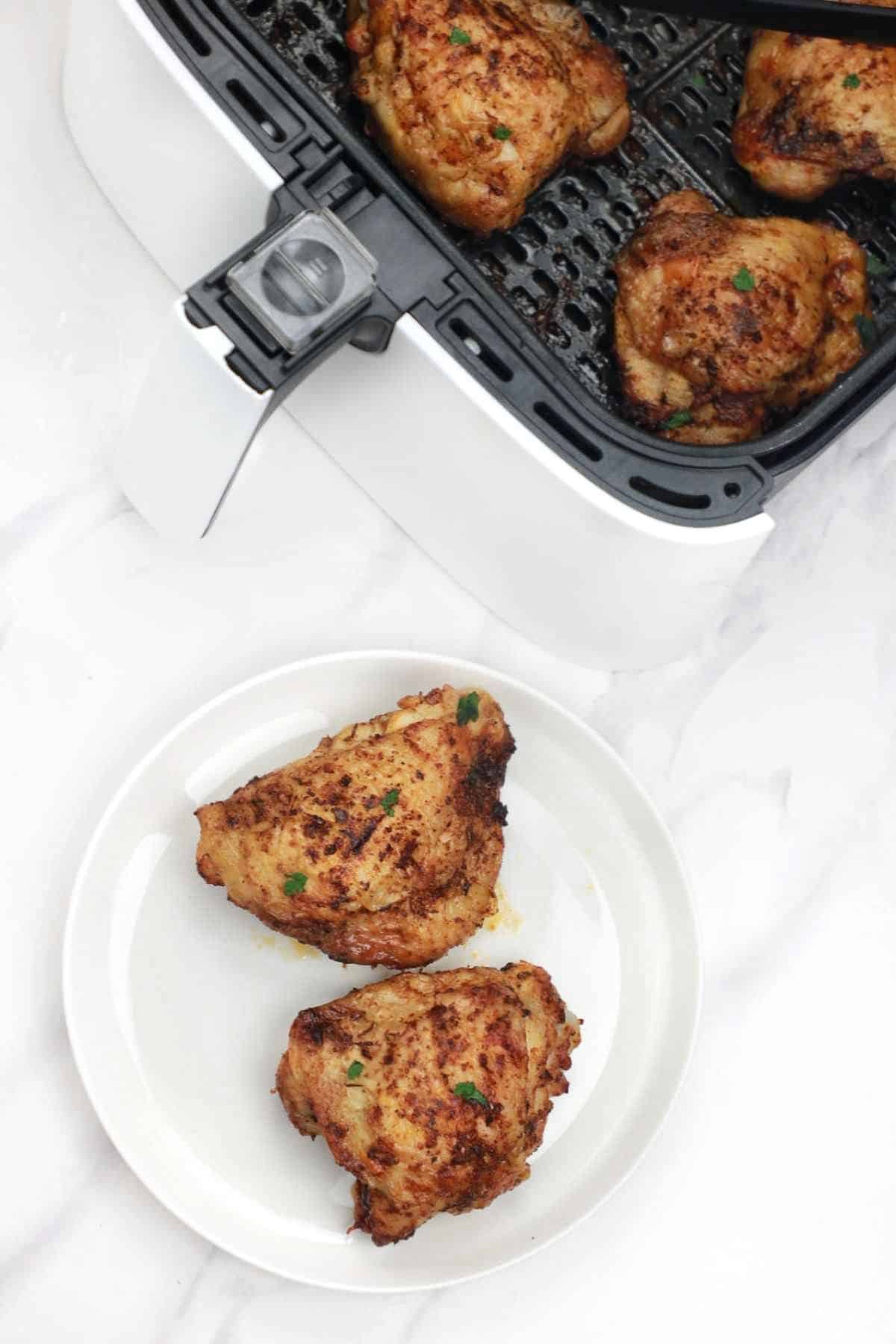 2 pieces served on a plate and the rest displayed in the air fryer.
