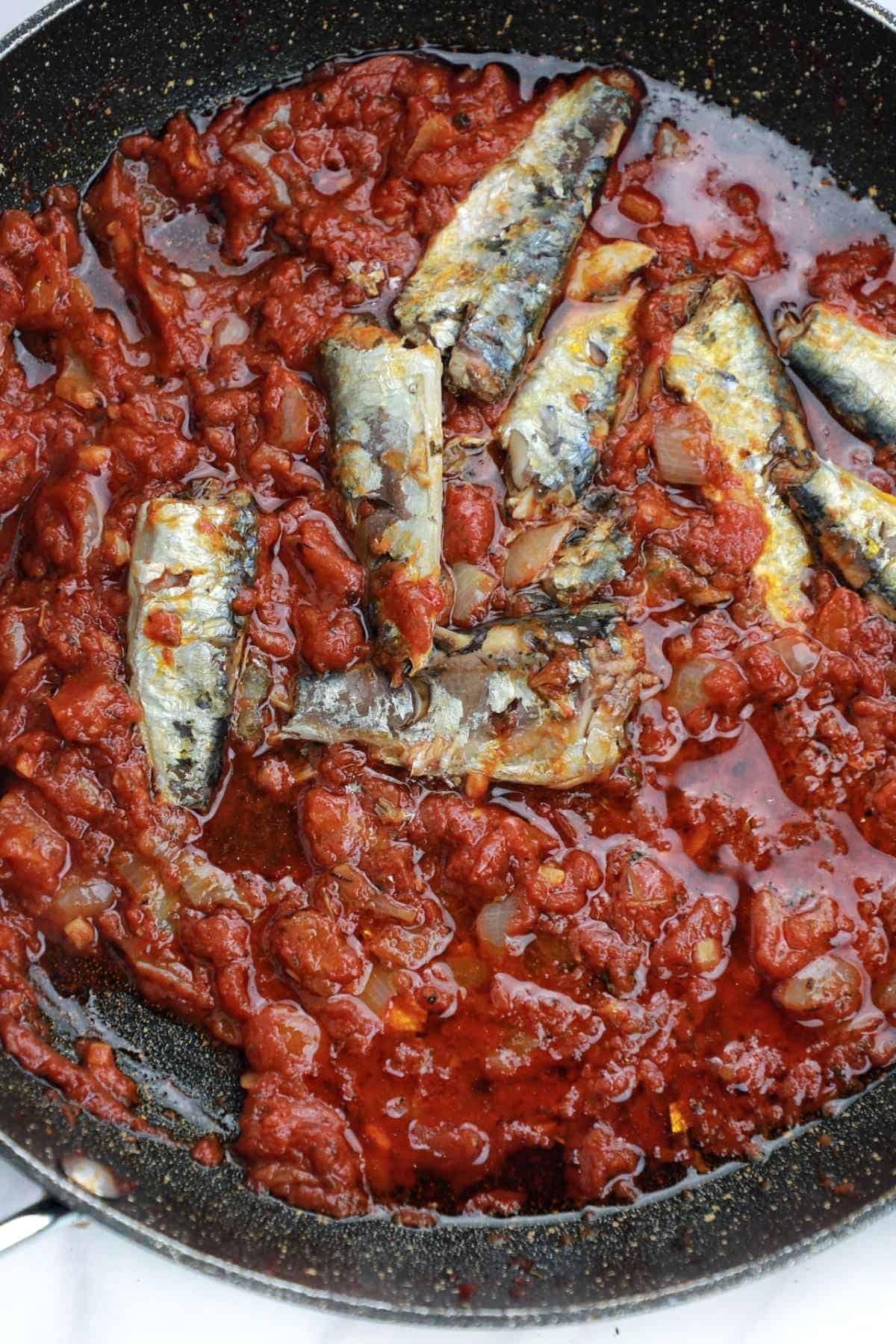 sardines added to the frying pan.