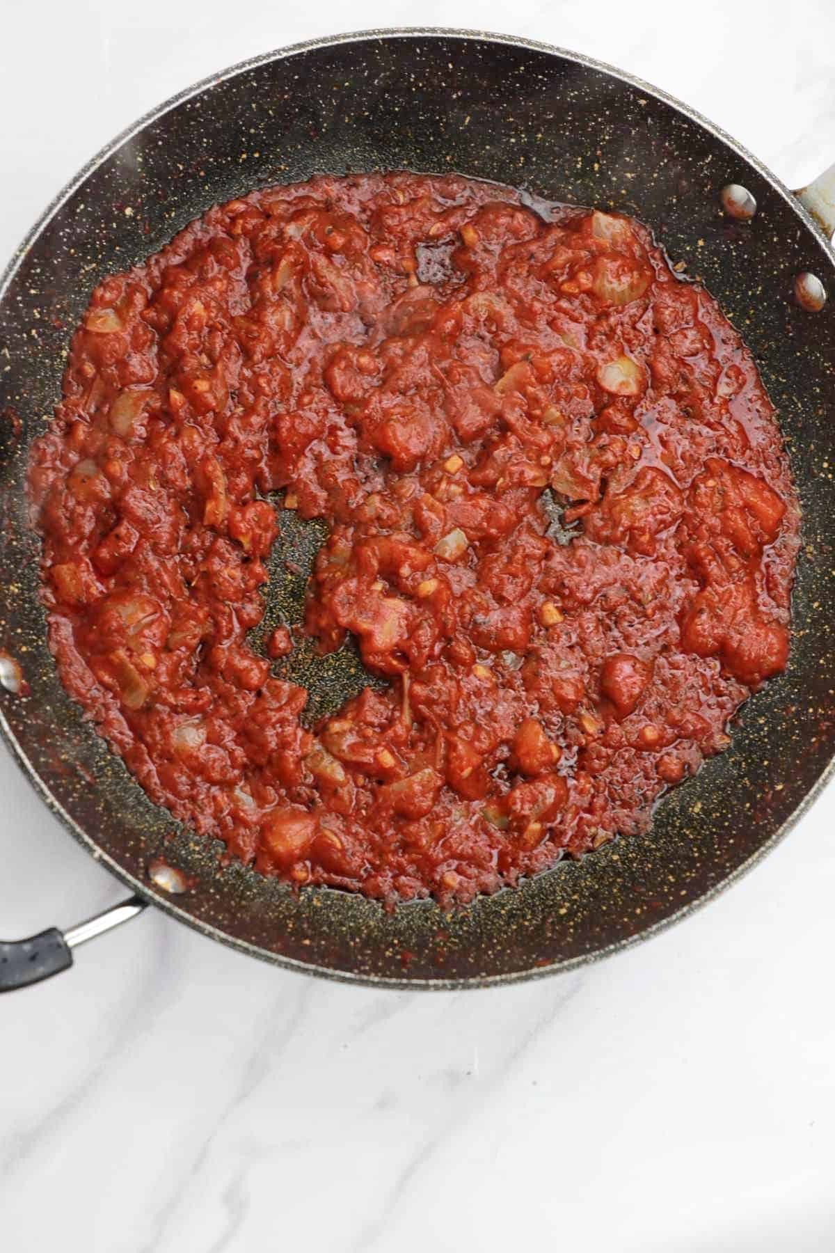 frying pan with cooked tomatoes.