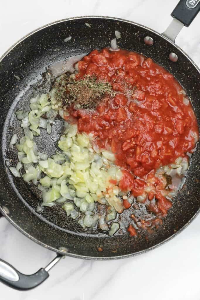 tomatoes, and seasoning, added to the pan.