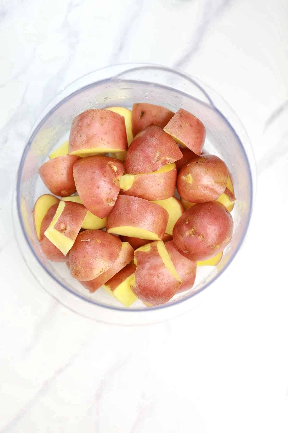 cut red potatoes in a bowl.