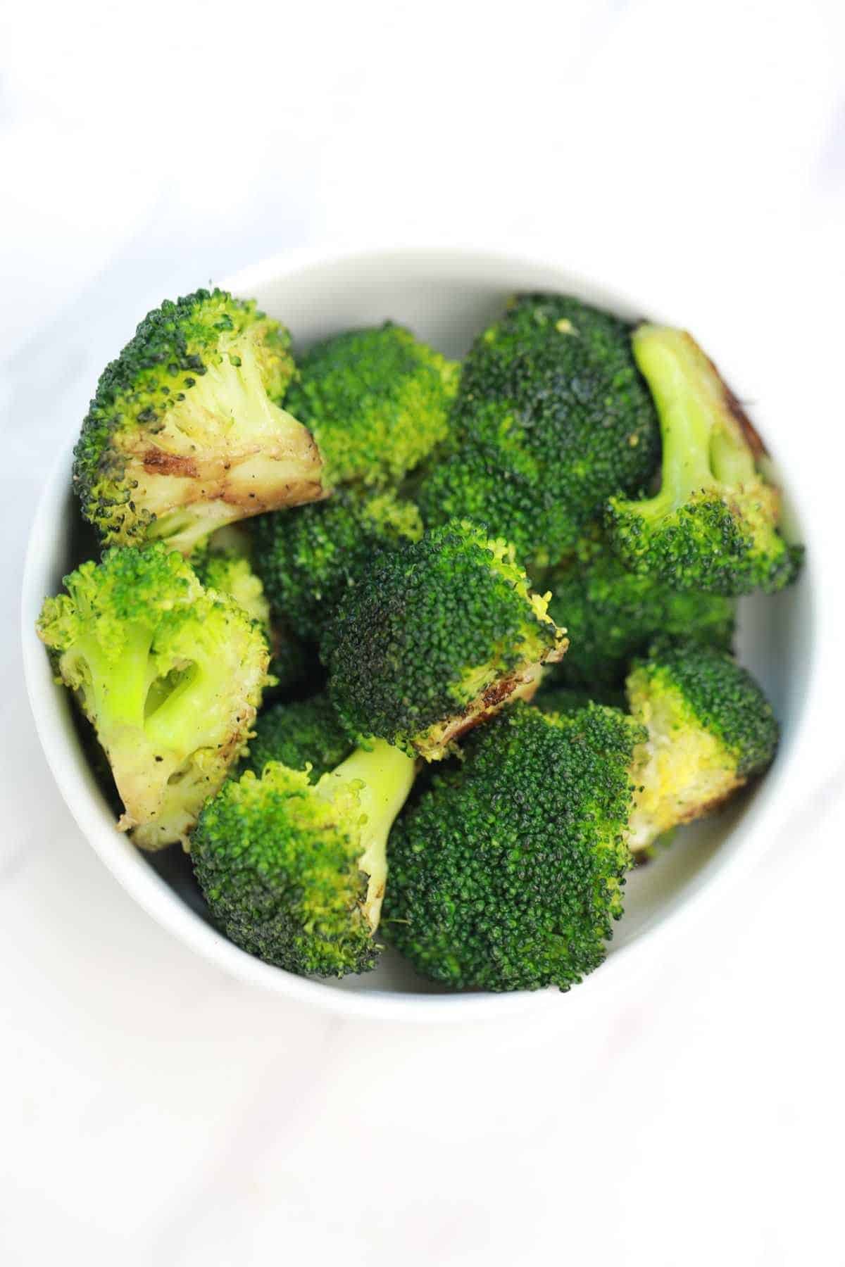 pan fried broccoli served in a white plate.