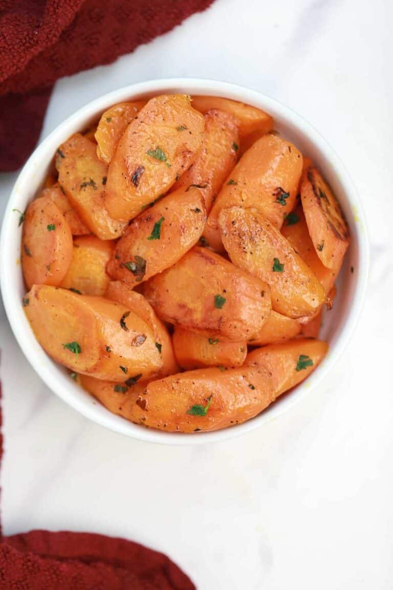the cooked carrots served in a white bowl.