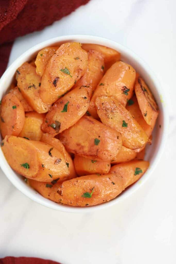 pan fried carrots in a white bowl.