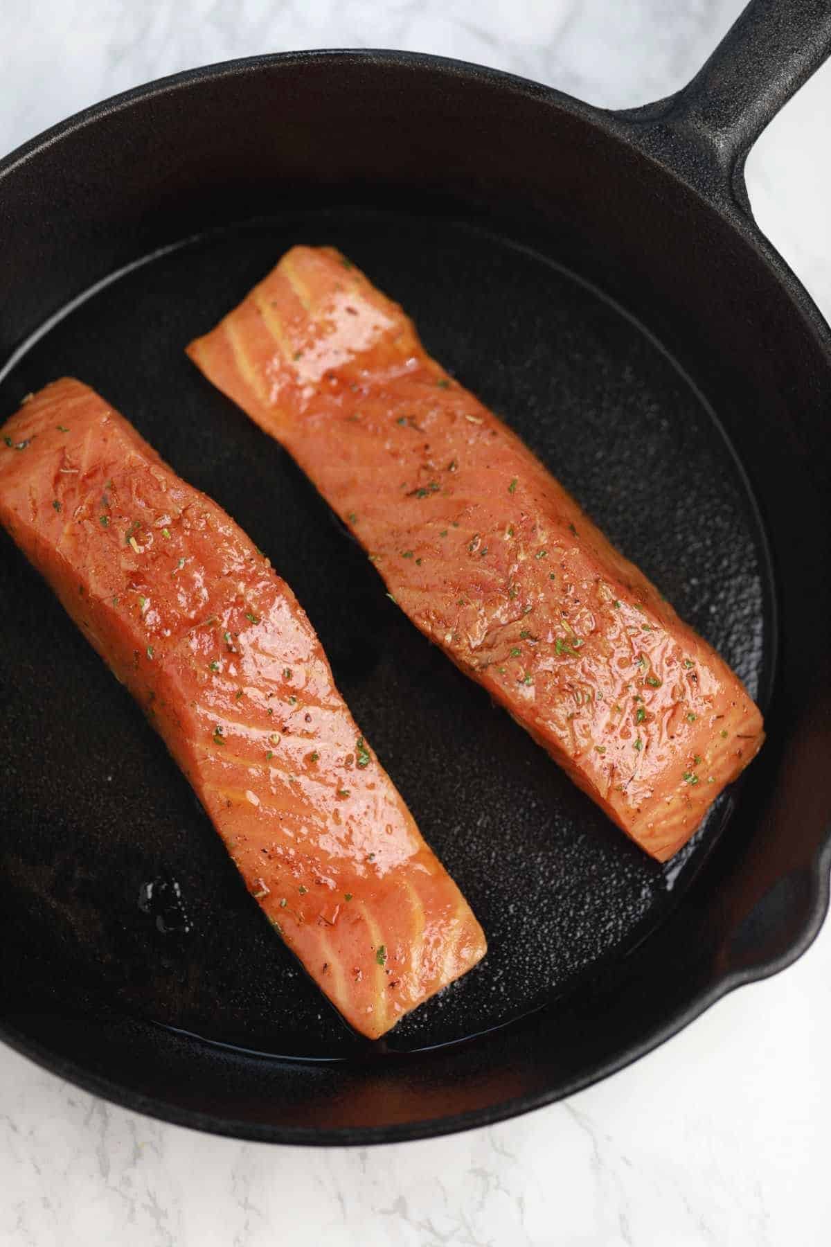 2 salmon fillets in a pan.