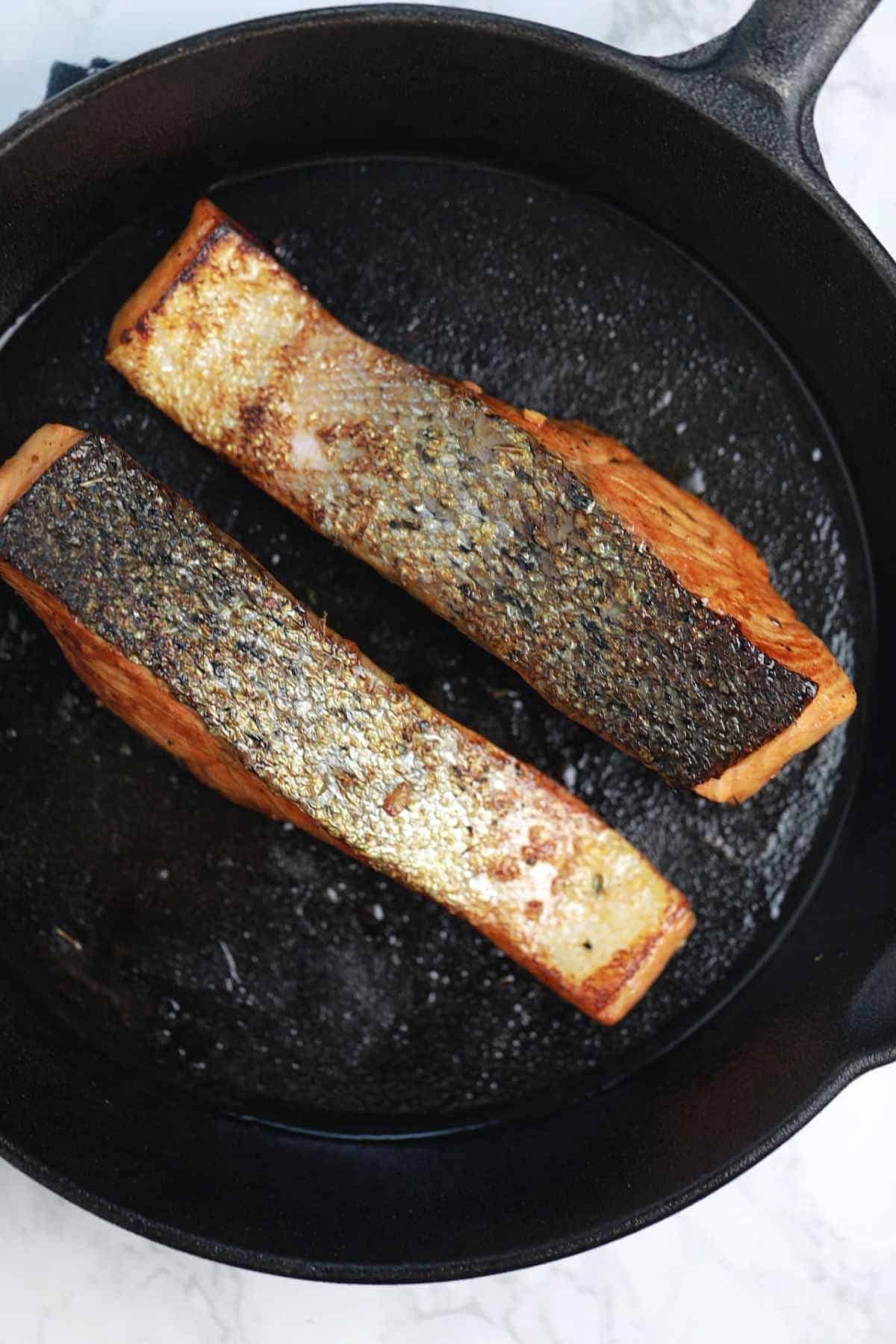 cooked salmon in a pan.