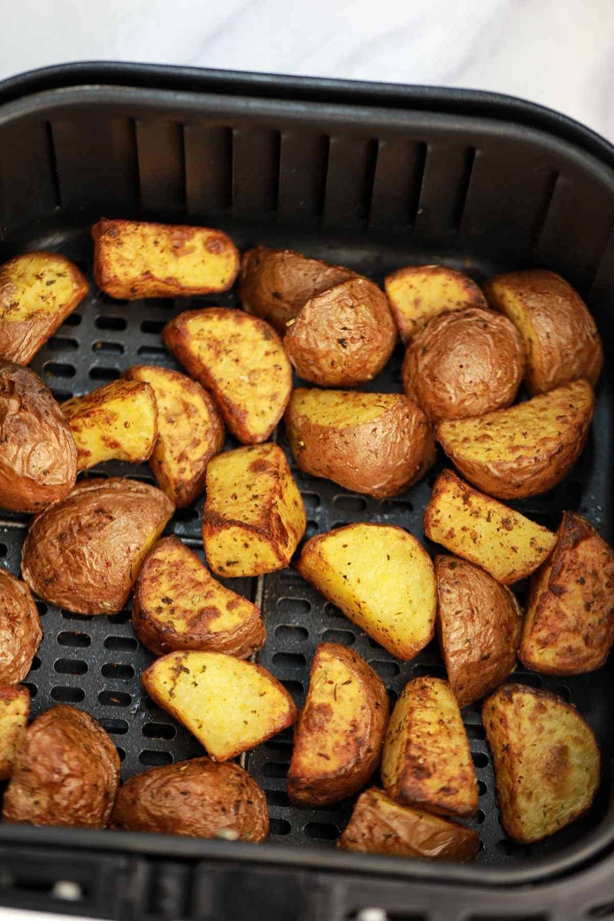 air fried red potatoes in air fryer basket.