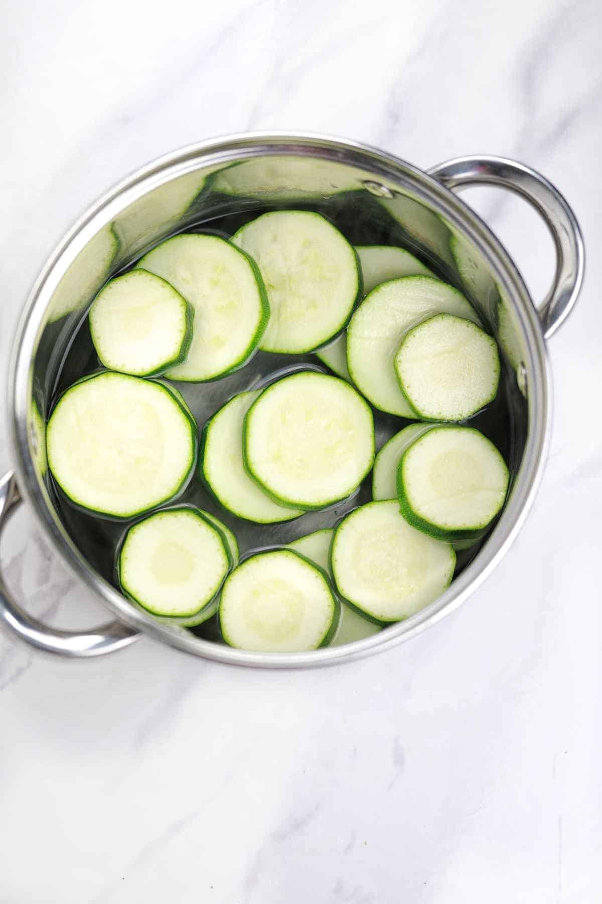 zucchini, salt, and water in a pot.