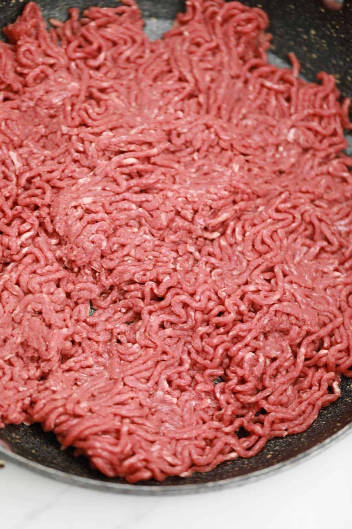 ground beef added to the pan.