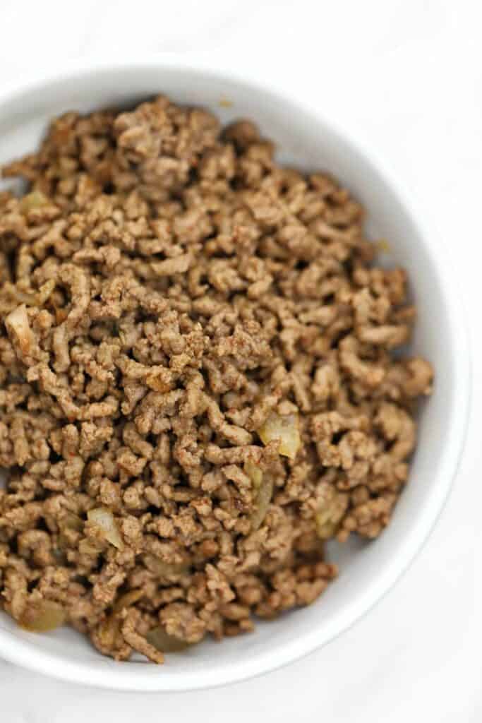 cooked ground beef served on a white plate.