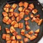 fried sweet potatoes in a pan.