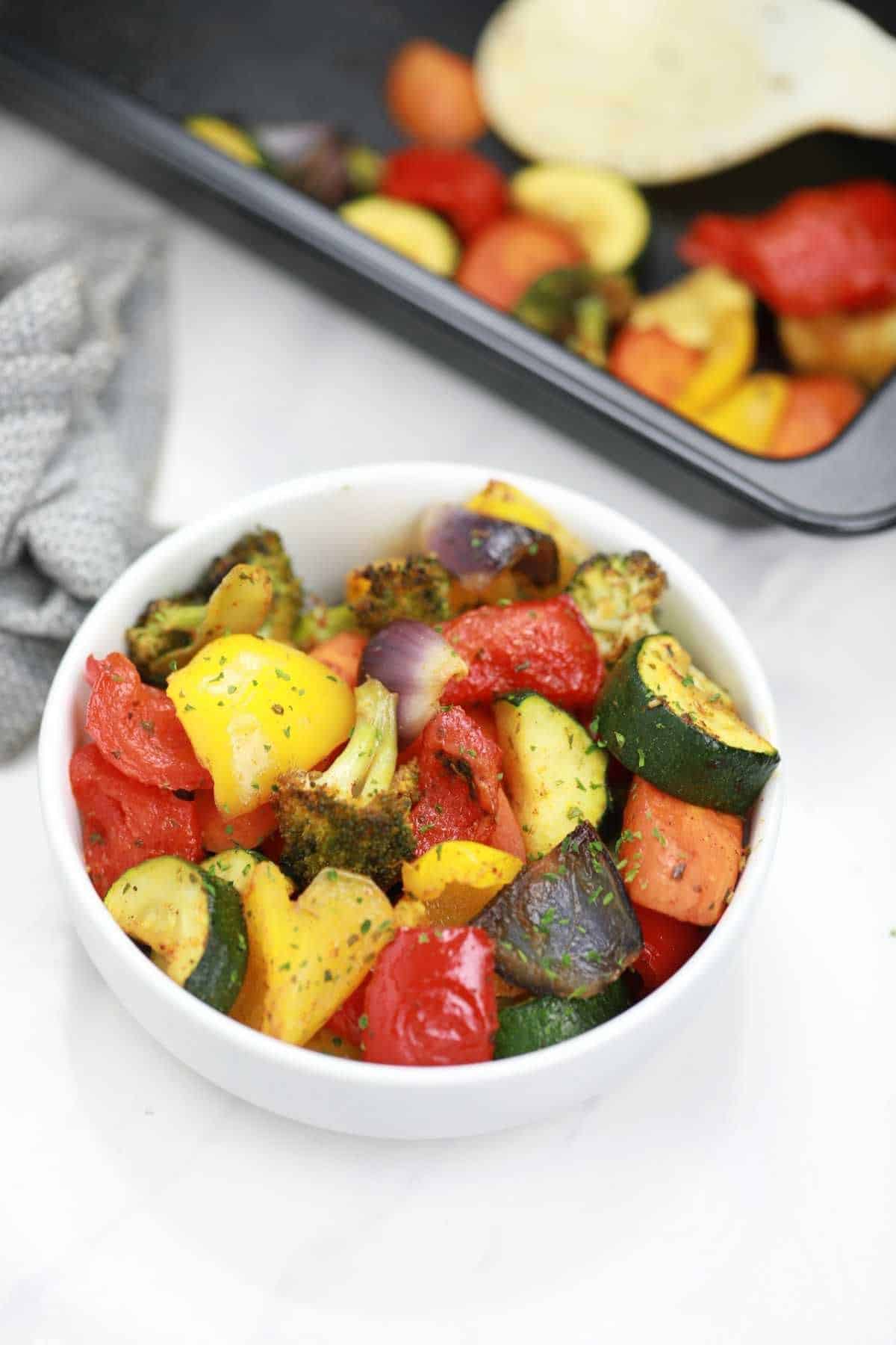 baked vegetables served in a white plate.